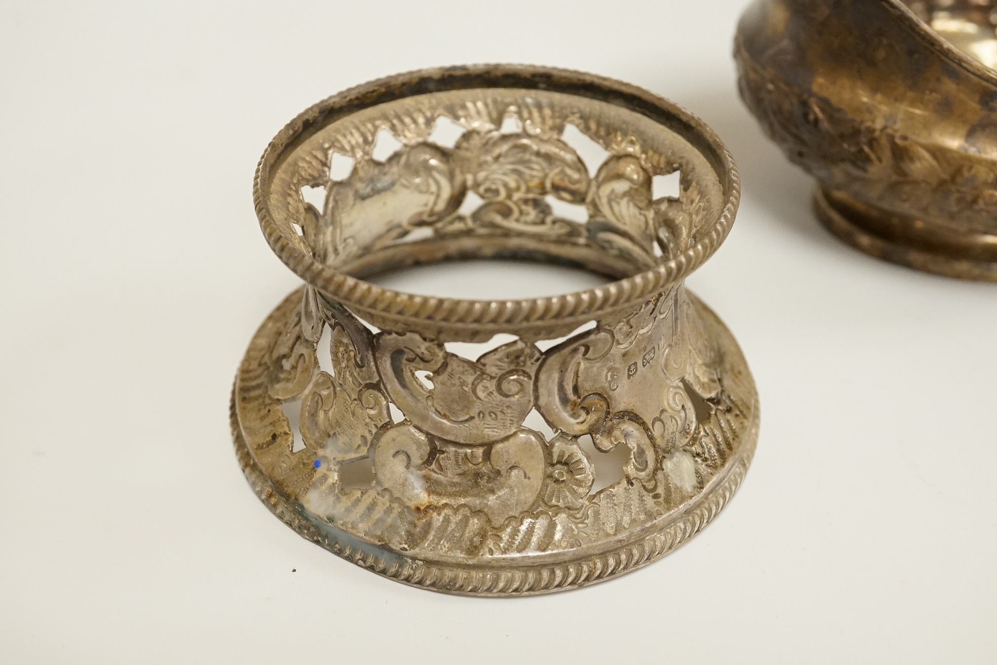A late George III Irish embossed silver sauce boat, with flying scroll handle, maker. ?S, Dublin, 1817, length 14cm, together with a small Edwardian silver dish ring, I S Greenberg & Co, Birmingham, 1901, 7.2oz.